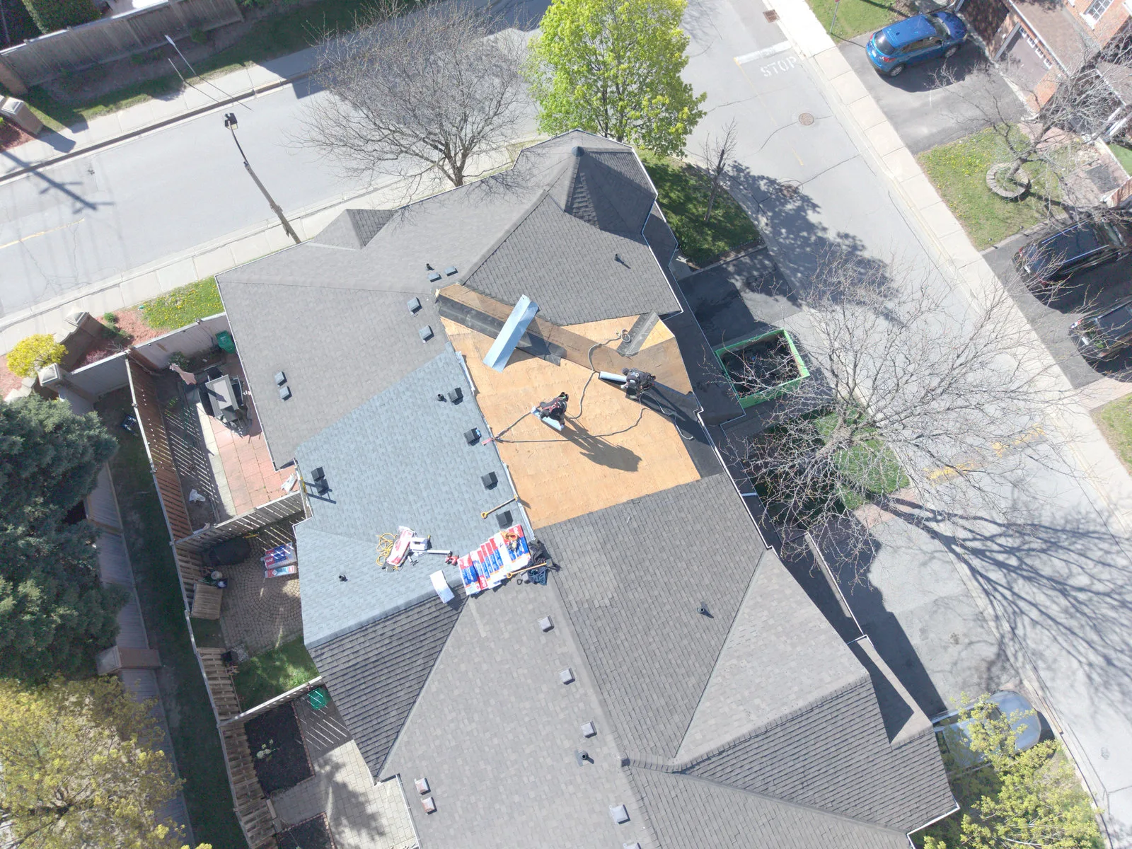 Roof replacement crew working on a Brampton home, aerial view