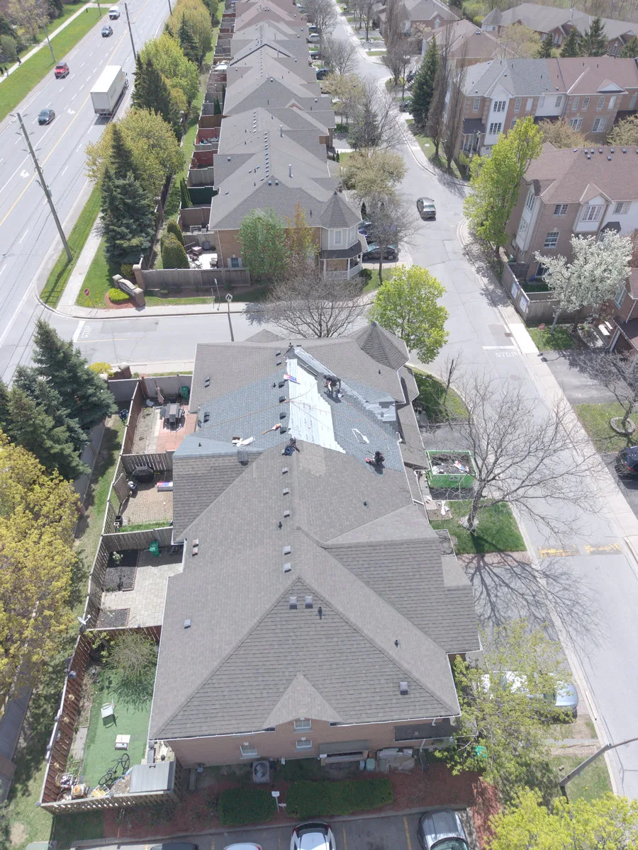 Roof tear-off exposing decking on a Brampton home, aerial view